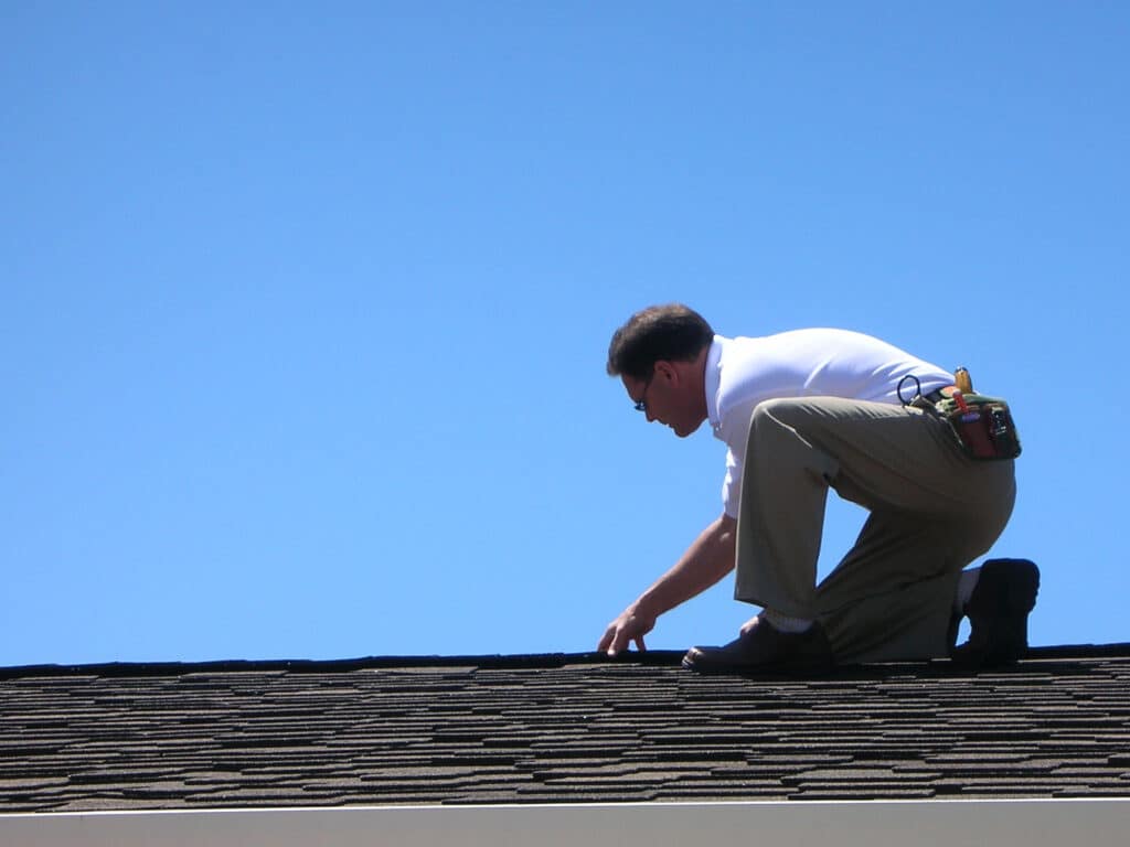Insurance Adjuster Inspecting Roof